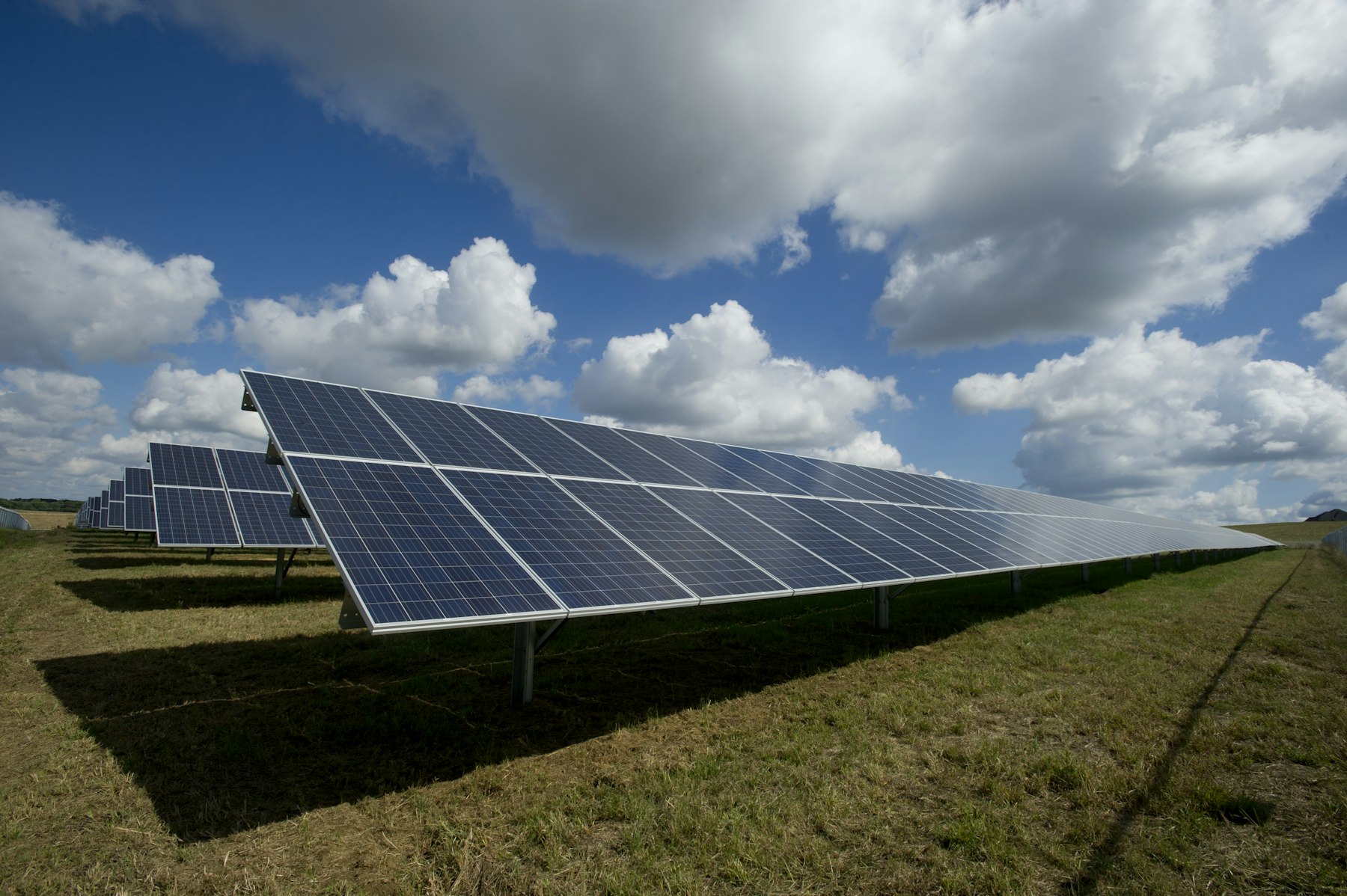 Large solar panel array under a bright sky