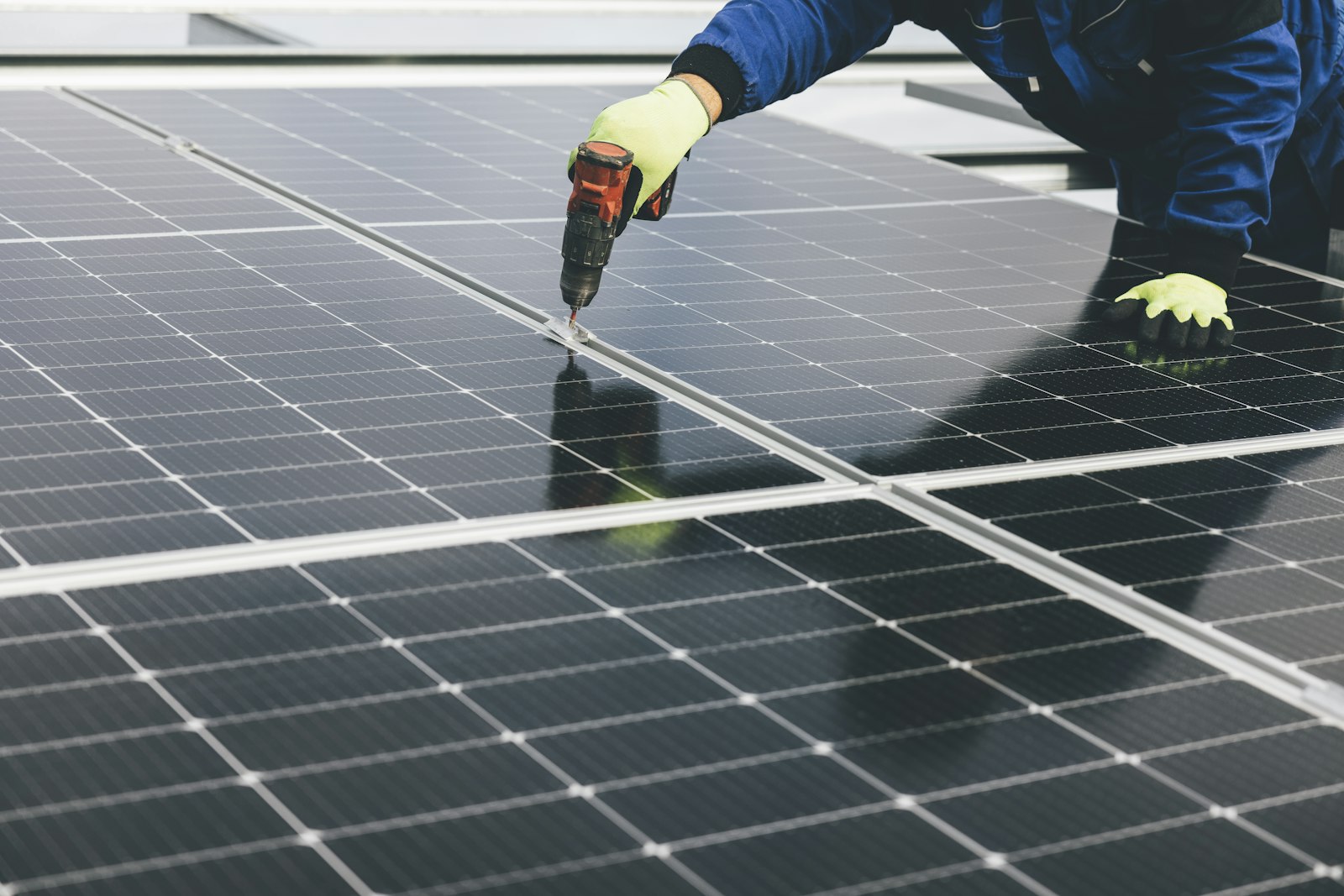 Technician fastening hardware on a solar panel installation